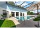 Outdoor pool area featuring clear blue water, lush greenery, and stylish lounge spots at 9353 Gotha Rd, Windermere, FL 34786