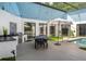 Relaxing indoor pool area features an outdoor kitchen, dining, and entertainment space at 9353 Gotha Rd, Windermere, FL 34786