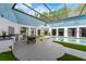Bright indoor pool area features an outdoor kitchen, dining, and entertainment space at 9353 Gotha Rd, Windermere, FL 34786