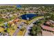 Aerial view of the community, showcasing homes surrounding a central lake at 100 Verde Way, Debary, FL 32713