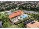 Aerial view of the community clubhouse, pool, and surrounding residential area at 100 Verde Way, Debary, FL 32713