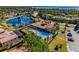 Aerial view featuring the pool, clubhouse, and landscaped grounds within the community at 100 Verde Way, Debary, FL 32713
