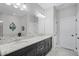 This bathroom has a soaking tub, a large mirror, double sinks and white cabinets at 100 Verde Way, Debary, FL 32713