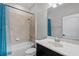 Bathroom with tub shower, single vanity, and neutral tile at 100 Verde Way, Debary, FL 32713