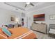 This bedroom has a tray ceiling, a ceiling fan, and a view into another room at 100 Verde Way, Debary, FL 32713