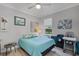 Cozy bedroom with light blue quilt, natural light, and a comfortable ambiance at 100 Verde Way, Debary, FL 32713