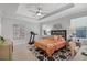 This bedroom has a tray ceiling, a ceiling fan, light wood floors and an exercise machine at 100 Verde Way, Debary, FL 32713