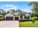 Beautiful single-story home with a three-car garage, well-manicured lawn and charming landscaping at 100 Verde Way, Debary, FL 32713