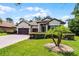 Attractive single-story home with three-car garage, beautiful landscaping and a brick driveway at 100 Verde Way, Debary, FL 32713