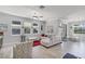 Open-concept living space featuring tile floors, a ceiling fan, and dining area access at 100 Verde Way, Debary, FL 32713