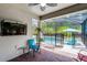 A screened patio with a brick floor, a ceiling fan and outdoor furniture at 100 Verde Way, Debary, FL 32713