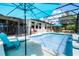 A screened pool with a waterfall feature, outdoor furniture and an outdoor kitchen at 100 Verde Way, Debary, FL 32713