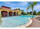 Resort-style community pool area with lounge chairs, palm trees, and a clubhouse for residents' enjoyment at 100 Verde Way, Debary, FL 32713