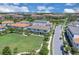 Captivating aerial view of a well-maintained community with manicured lawns, scenic ponds, and stylish townhomes at 10120 Sunnifa Aly, Orlando, FL 32832
