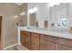 Bathroom features double sink, granite countertops, wood cabinets, and glass shower at 10120 Sunnifa Aly, Orlando, FL 32832