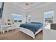 Bedroom featuring ample natural light, tray ceilings, modern furniture and large windows at 10120 Sunnifa Aly, Orlando, FL 32832