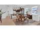 Bright dining area featuring modern pendant lighting, a stylish round table, and a seamless transition to the kitchen at 10120 Sunnifa Aly, Orlando, FL 32832