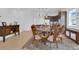 The dining room features a round table, chandelier and floral carpet at 10120 Sunnifa Aly, Orlando, FL 32832