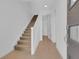Inviting entryway with stairs, light tile, and neutral decor at 10120 Sunnifa Aly, Orlando, FL 32832