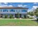 Inviting two-story home with a well-manicured lawn, lush landscaping, and a charming brick pathway leading to the front door at 10120 Sunnifa Aly, Orlando, FL 32832
