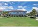 Stunning townhome exterior with lush green lawn and palm trees showcasing a desirable community at 10120 Sunnifa Aly, Orlando, FL 32832