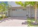 Attached garage with brick driveway and landscaping at 10120 Sunnifa Aly, Orlando, FL 32832