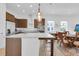 Open kitchen with large island, stainless appliances, and pendant lighting at 10120 Sunnifa Aly, Orlando, FL 32832