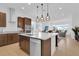 Modern kitchen featuring large island, granite countertops, and stainless steel appliances at 10120 Sunnifa Aly, Orlando, FL 32832