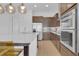 Kitchen featuring stainless steel appliances, modern cabinetry, and stone countertops at 10120 Sunnifa Aly, Orlando, FL 32832
