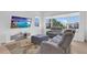 Relaxing living room featuring comfortable seating, large windows, and a modern entertainment center at 10120 Sunnifa Aly, Orlando, FL 32832