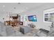 Open-concept living room with modern furniture, recessed lighting, and a view to the kitchen at 10120 Sunnifa Aly, Orlando, FL 32832