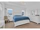 Bright main bedroom features plush carpet, windows, and custom white headboard at 10120 Sunnifa Aly, Orlando, FL 32832