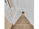 Interior view of a carpeted staircase with white railings at 10120 Sunnifa Aly, Orlando, FL 32832