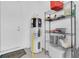 Utility room with water heater, storage rack, and door at 10120 Sunnifa Aly, Orlando, FL 32832