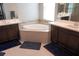 Luxurious bathroom with a soaking tub and double vanities at 14146 Jomatt Loop, Winter Garden, FL 34787