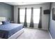 Spacious bedroom featuring a plush bed, neutral carpet and ample natural light at 14146 Jomatt Loop, Winter Garden, FL 34787
