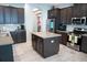 Spacious kitchen with an island, stainless steel appliances, and dark cabinetry at 14146 Jomatt Loop, Winter Garden, FL 34787
