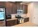 Modern kitchen featuring stainless steel appliances and dark wood cabinets at 14146 Jomatt Loop, Winter Garden, FL 34787