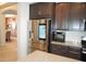 Kitchen with stainless steel refrigerator, appliances, and brown cabinets at 14146 Jomatt Loop, Winter Garden, FL 34787