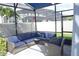 Enclosed lanai with comfortable blue cushioned wicker seating, offering a serene outdoor living space at 14146 Jomatt Loop, Winter Garden, FL 34787