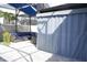 Relaxing lanai featuring comfortable wicker furniture, privacy curtains, and a cool shaded area perfect for entertaining at 14146 Jomatt Loop, Winter Garden, FL 34787