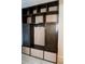 Custom mudroom with dark wood cabinets and light wood trim at 14146 Jomatt Loop, Winter Garden, FL 34787