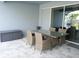 Comfortable covered patio with a glass table and wicker chairs perfect for outdoor enjoyment at 14146 Jomatt Loop, Winter Garden, FL 34787