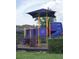 Brightly colored community playground area with a slide, climbing structures, and safety features at 14146 Jomatt Loop, Winter Garden, FL 34787
