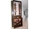 Custom built-in wooden wine bar featuring ample bottle and glass storage in a well lit area of the home at 14146 Jomatt Loop, Winter Garden, FL 34787