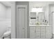 Bright bathroom features a dual sink vanity with white cabinetry and modern fixtures at 16262 Firedragon Dr, Winter Garden, FL 34787