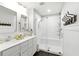 Modern bathroom featuring a double vanity and glass-enclosed shower at 16262 Firedragon Dr, Winter Garden, FL 34787