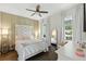 Comfortable bedroom with a statement headboard, soft lighting, and large windows with backyard views at 16262 Firedragon Dr, Winter Garden, FL 34787