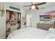 Well-lit bedroom features a ceiling fan, closet, and tv for comfortable living at 16262 Firedragon Dr, Winter Garden, FL 34787