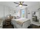 Cozy bedroom features a ceiling fan, window with natural light, and stylish decor at 16262 Firedragon Dr, Winter Garden, FL 34787